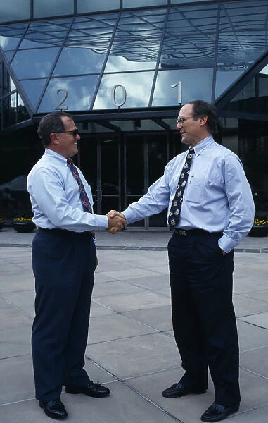 USA, Florida, Orlando Two businessmen in conversation shaking hands outside modern