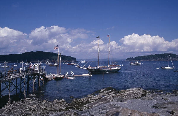 USA, Maine, Bar Harbour Wooden jetty with approaching yacht