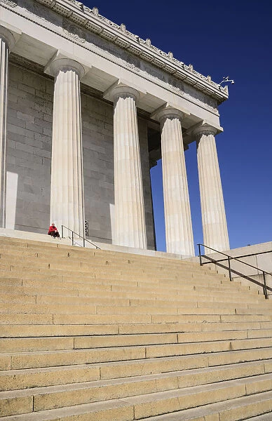 USA, Washington DC, National Mall, Lincoln Memorial, A tourist sitting among the Doric