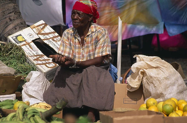 WEST INDIES, St Maarten, Marigot Woman stallholder in fruit and vegetable market