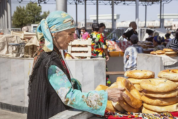 Woman buying non bread, Siyob Market, also known as Siab Market, Samarkand, Uzbekistan