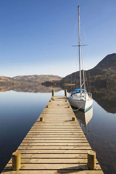 Yacht moored at a jetty on Lake Ullswater, Glenridding, Lake District, Cumbria, England