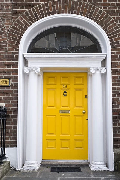 Yellow door in Georgian doorway