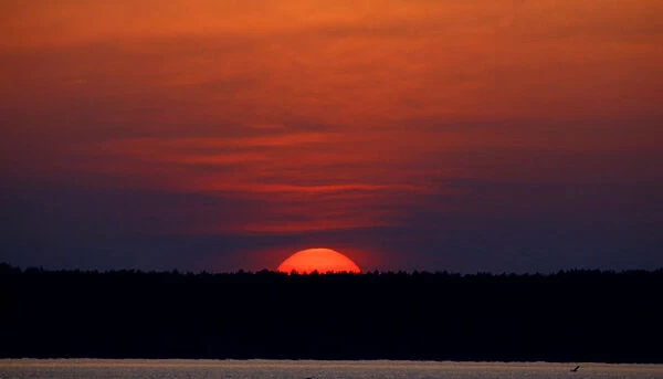 Sun sets behind a lake on the outskirt of Minsk