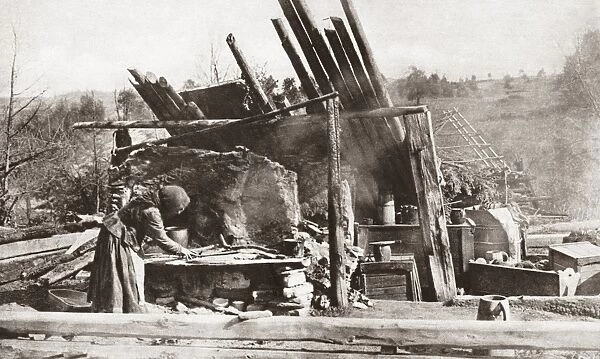 WORLD WAR I: RUINS. A Russian peasant trying to prepare a meal at her ruined home