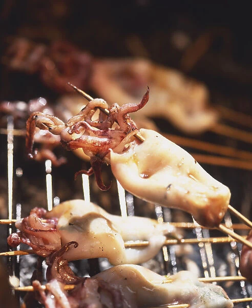 Close-up of skewered Baby Squid Stuffed with Coriander and Pickled Ginger