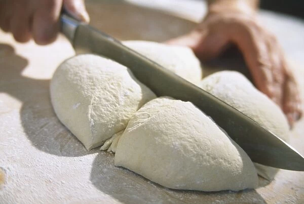 Cutting dough into quarters