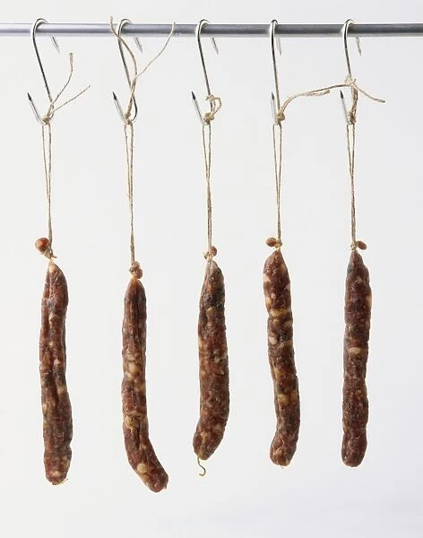 Dried salami hanging on hooks