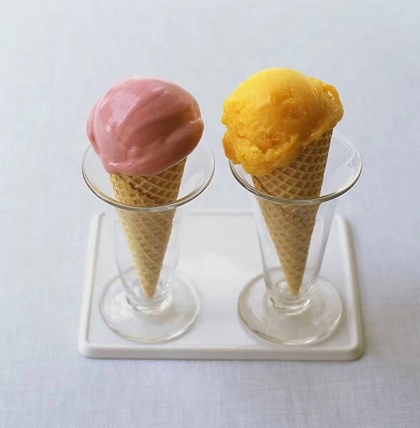 Raspberry and mango ice cream cones in tall glasses on tray