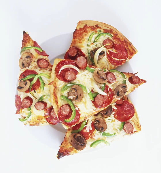 Four slices of pizza topped with sausage, mushrooms, green bell pepper and onion rings