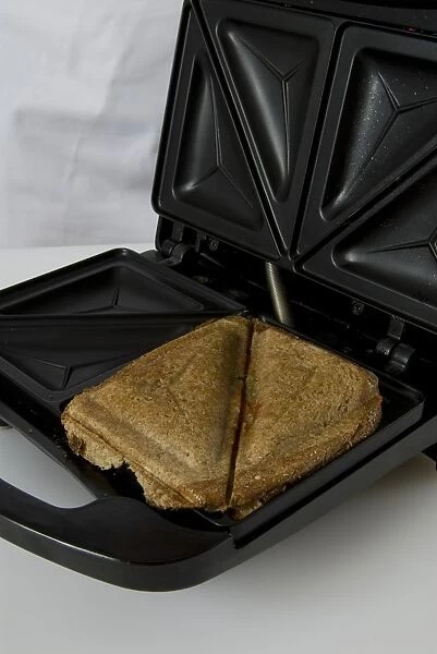 Toasted sandwiches in sandwich maker, close-up