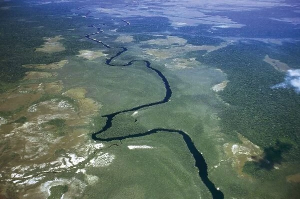 Venezuela, Guayana, Amazonas, Orinoco river flows through forest, aerial view
