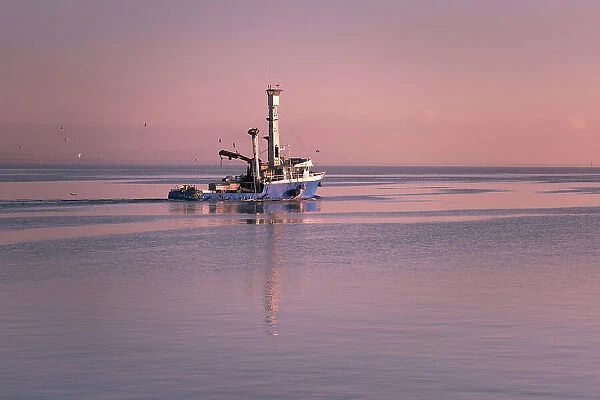 Fishing vessel of to work at Sunrise
