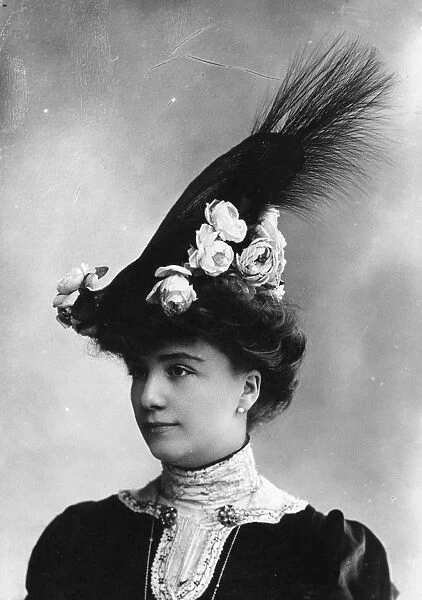 High Hat. circa 1903: An Edwardian woman wearing a high hat, decorated with flowers