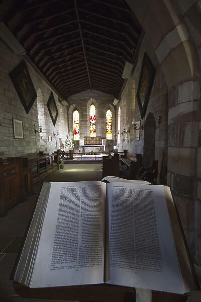 View Of The Interior Of A Church With Stained Glass Windows And An Open Bible; Bamburgh, Northumberland, England