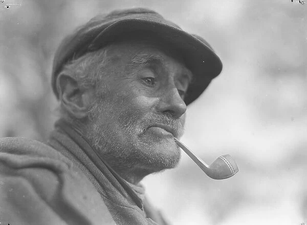 A gentleman of the road in deep contemplation with his pipe