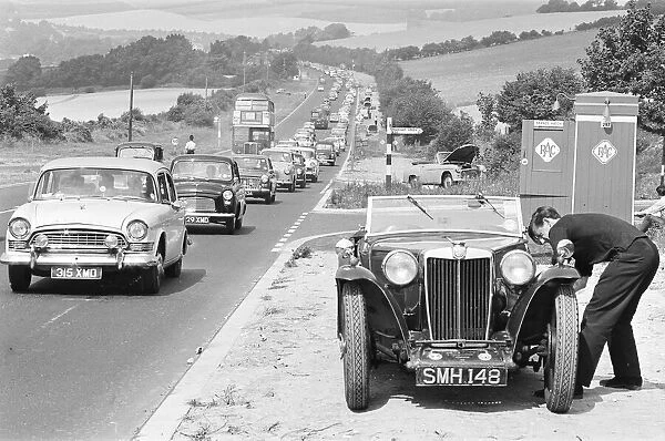 Mortorist seen here trying to repair his MG as heavy August Bank Holiday traffic