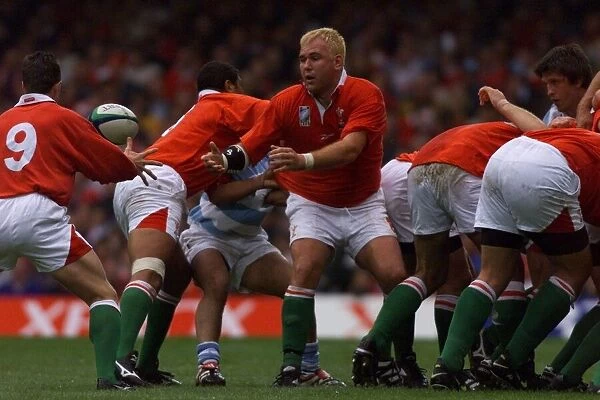 Scott Quinnell passes to Rob Howley in October 1999, during the Wales v Argentina rugby