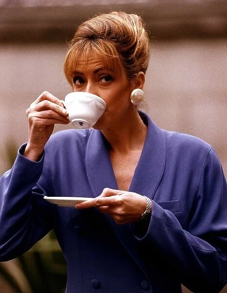Sharon Maughan actress drinking a cup of coffee during recording of an advert for Gold