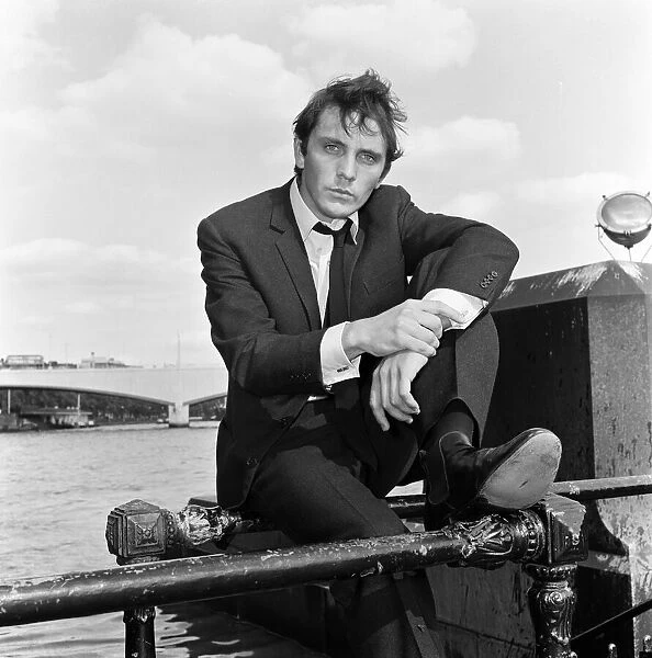 Terence Stamp actor sitting on railing beside the River Thames. 13th September 1962