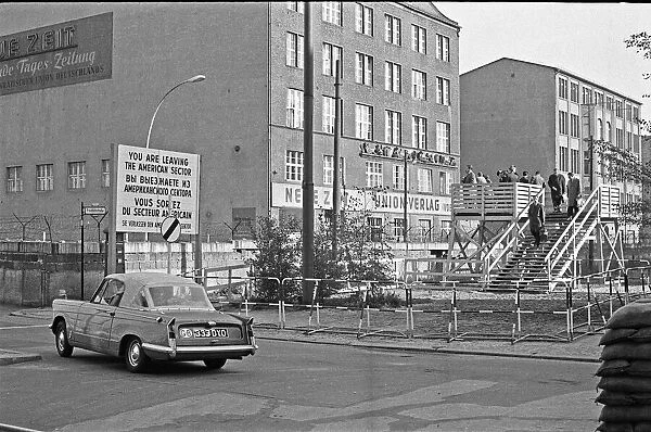 A Triumph Herald crossing the Berlin Wall at Checkpoint Charlie