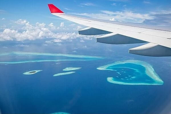 Airplane interior with window view of Maldives island. Concept of travel and air transportation. Maldives islands top view airplane, luxury tourism