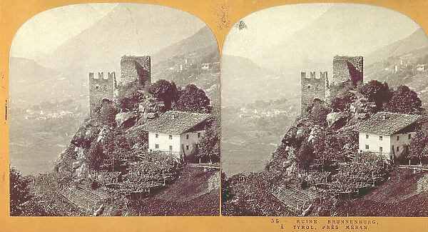 Mountain landscape near Merano (Trentino-Alto Adige). In the foreground, the ruins of the Castle of Brunnen, with a house next to it and surrounded by vegetable gardens