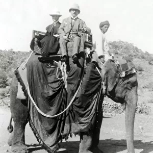 Colonial India, British gents ride on an elephant