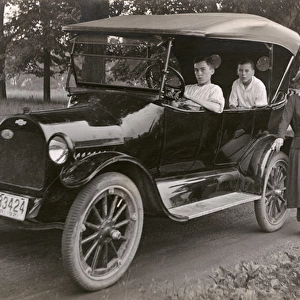 Family of four with their car, Rhode Island, USA
