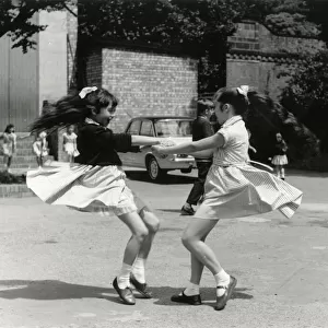 TWO GIRLS WHIRLING ROUND