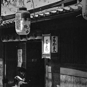 A Japanese girl sits outside a theatre
