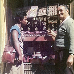 Lorna Holder talking to a shopkeeper outside jewellery shop