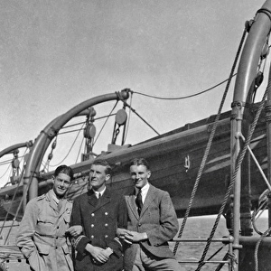 Three men on the deck of a ship