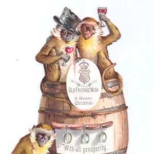 Three monkeys with barrel on a cutout Christmas card