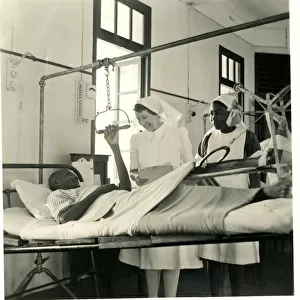 Nurses with patient in traction at the African Hospital, Lag