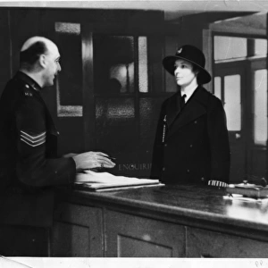Two police officers in a police station, London