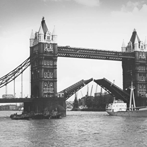 Tower Bridge, London - opening up for cargo vessel to pass u