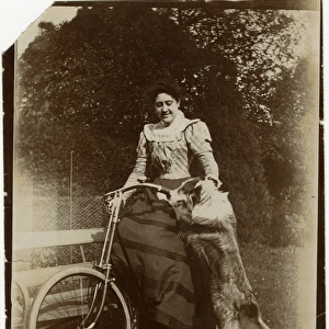 Woman with dog and bicycle in a garden