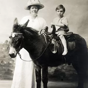 Young Boy and his Mother - Studio photo on a donkey