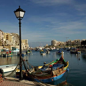 Malta - Spinola Bay - once a thriving fishing port, but in recent years tourism has taken over. The brighly coloured traditional Maltese fishing boats are called "Luzzu". November