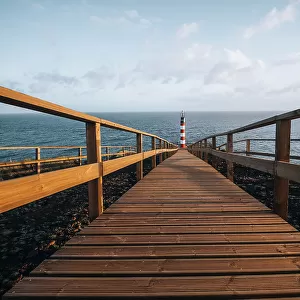 Farolim dos Fenais da Ajuda lighthouse with a symmetrical wooden path leading to it, Sao Miguel island, Azores Islands, Portugal, Atlantic, Europe