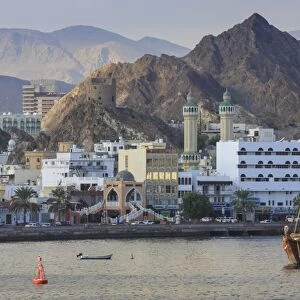 Mutrah Corniche and entrance to Mutrah Souq, backed by mountains, viewed from the sea