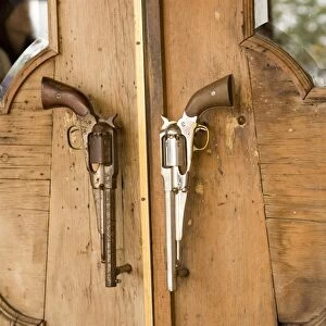 A pair of guns on doorway to restaurant in Houston, Texas, United States of America