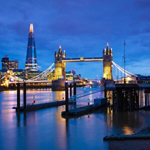Tower Bridge and The Shard at sunset with a low tide on the River Thames, London, England