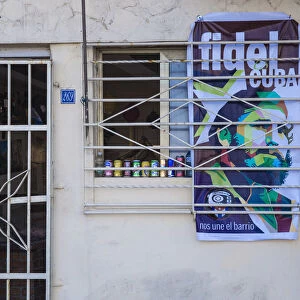 Cuba, Havana, Buildings on The Malecon, Poster of Fidel on shop wall after the death