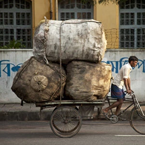 Dhaka, Bangladesh. A rickshaw rider transports goods around the capital
