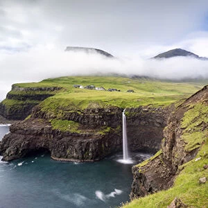 Mulafossur waterfall and the little village of Gasadalur, Vagar island, Faroe Islands