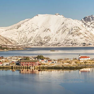 Sildpollneset peninsula with its church and snowcapped mountains in the background