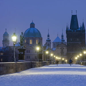 Snow-covered Charles Bridge at twilight in winter, Prague, Bohemia, Czech Republic