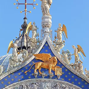 A detail of the St Mark's Basilica church gable showing Venice patron Apostle St. Mark with the angels, Saint Mark square, Venice, Veneto, Italy, Europe